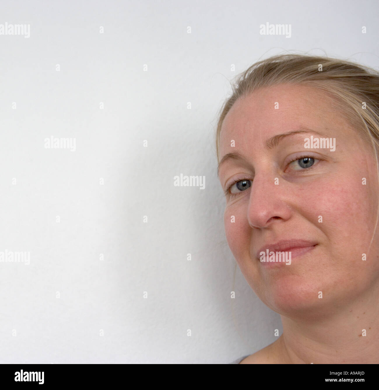 Young woman with enigmatic expression Stock Photo