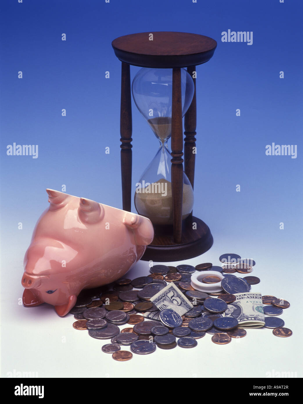 OPENED EMPTY PIGGY BANK AMERICAN COINAGE BILLS AND SAND HOURGLASS TIMER Stock Photo Alamy