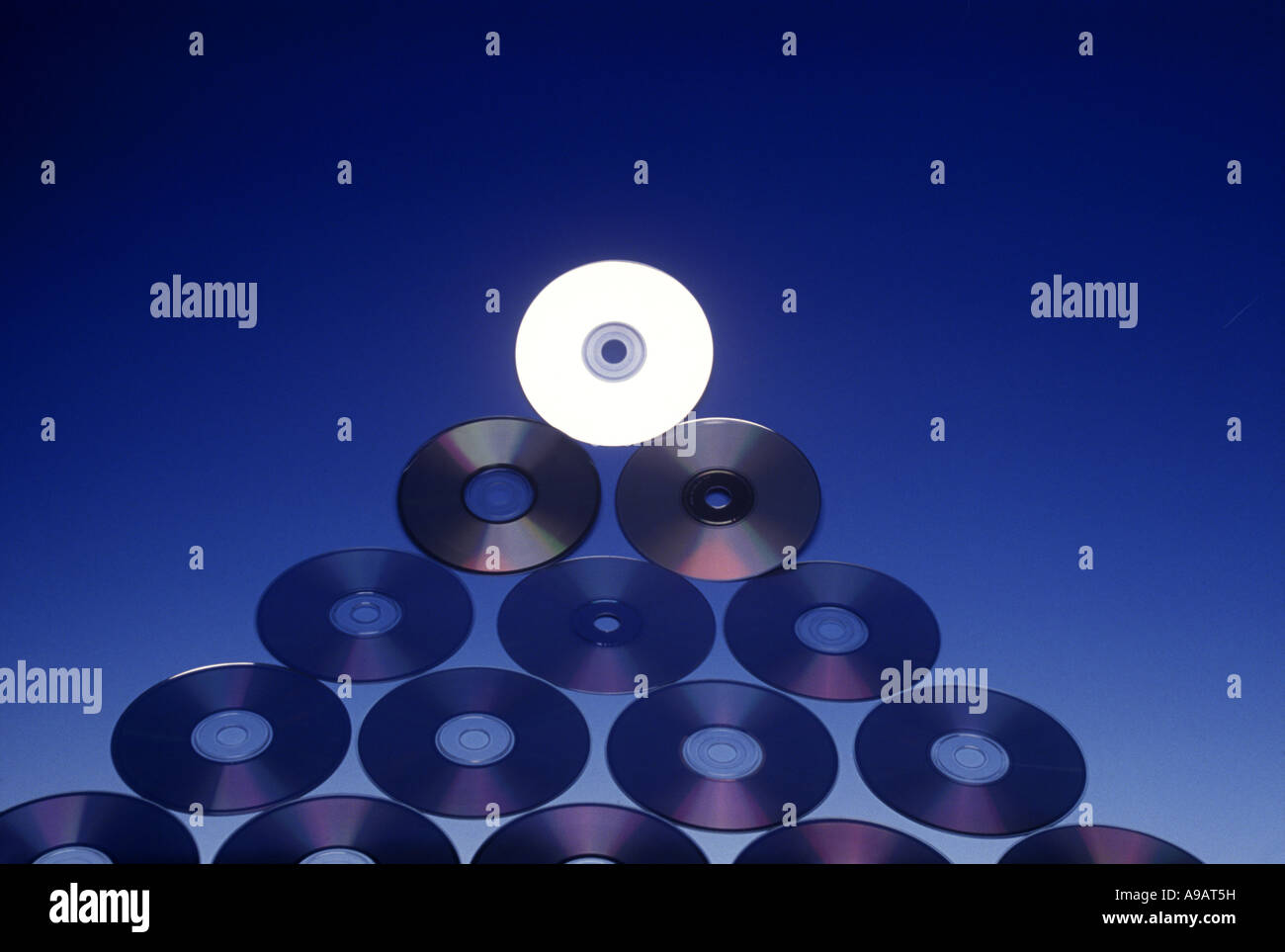 PYRAMID OF COMPACT CD ROM DISCS ON BLUE BACKGROUND Stock Photo Alamy