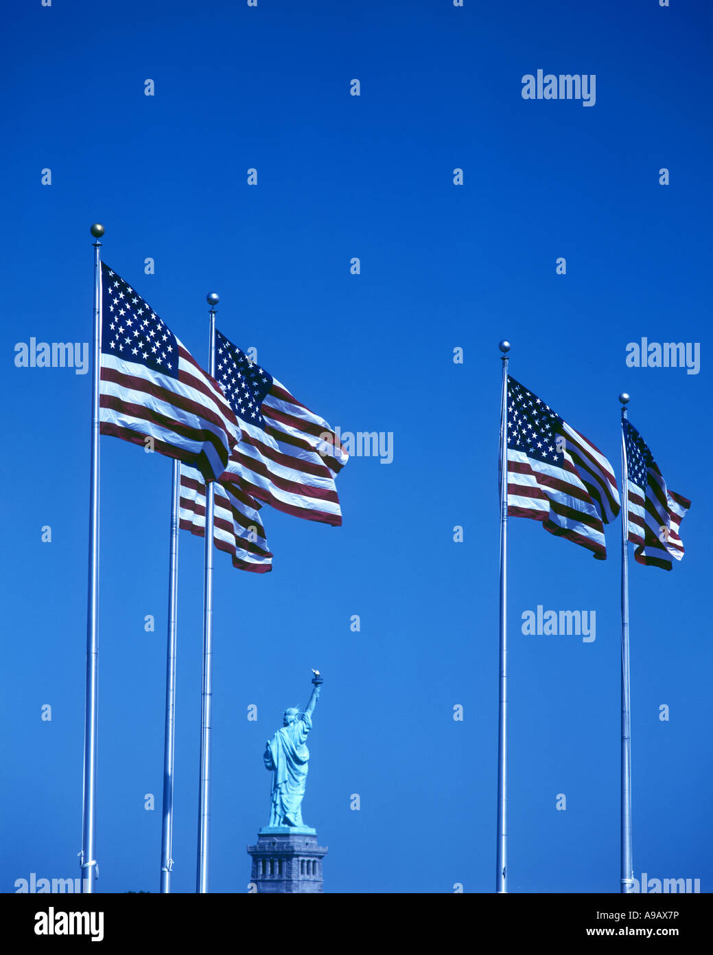 ROW OF UNITED STATES FLAGS STATUE OF LIBERTY NATIONAL MONUMENT LIBERTY ...