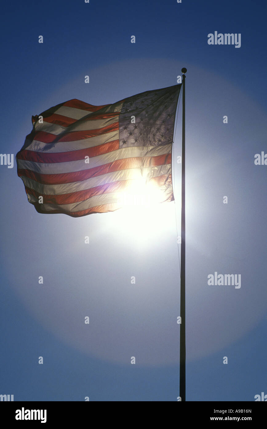 UNITED STATES FLAG FLYING ON FLAGPOLE WITH BLUE SKY Stock Photo - Alamy