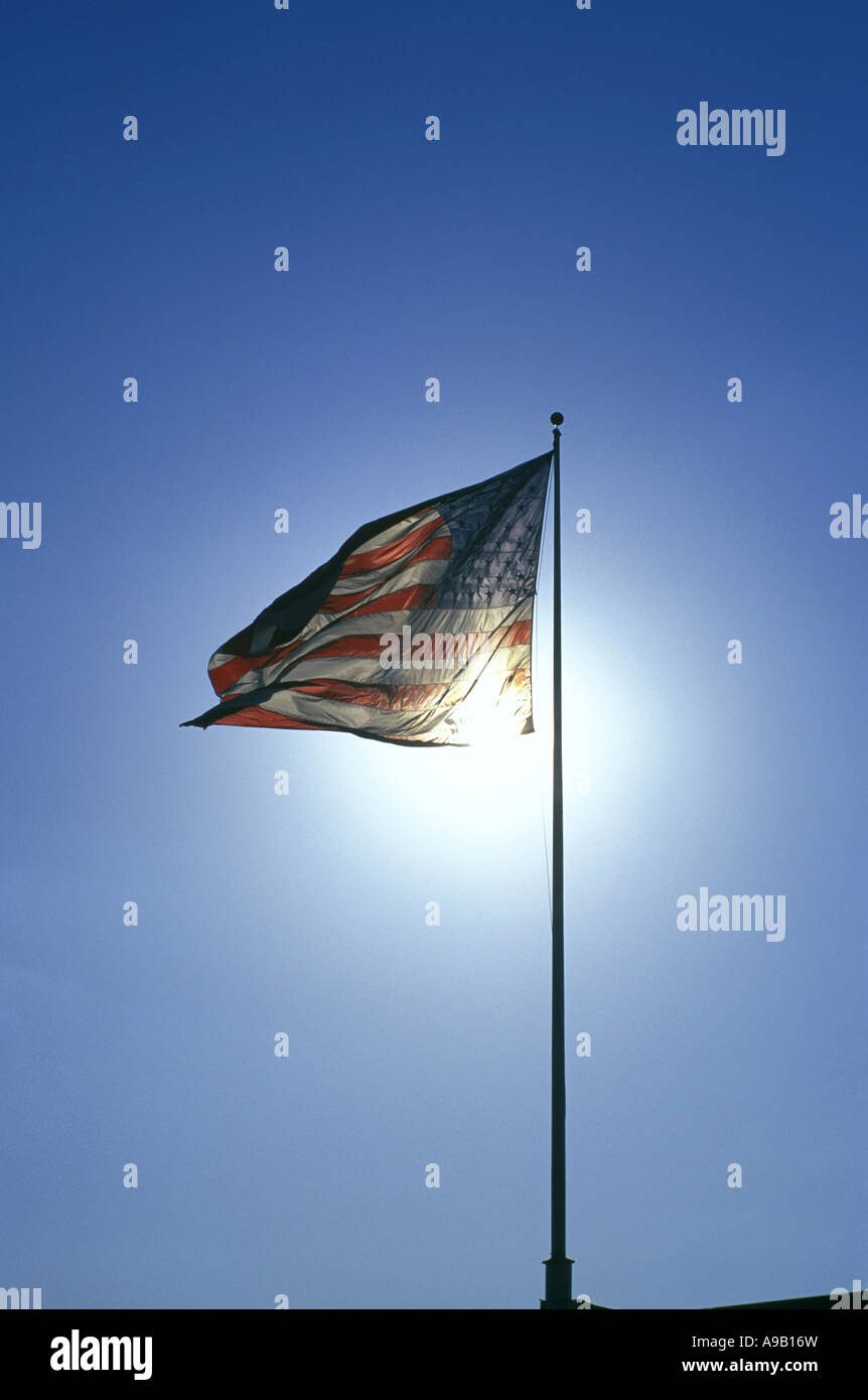 UNITED STATES FLAG FLYING ON FLAGPOLE WITH BLUE SKY Stock Photo - Alamy