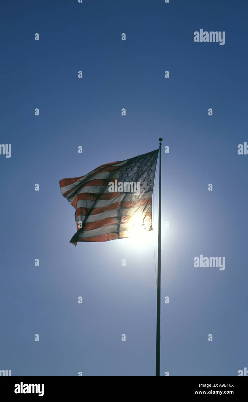 UNITED STATES FLAG FLYING ON FLAGPOLE WITH BLUE SKY Stock Photo - Alamy