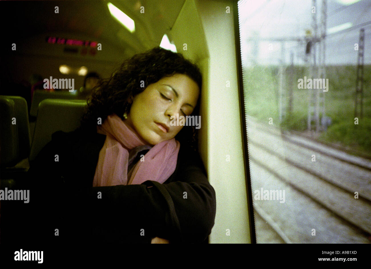 Woman on train sleeping hi-res stock photography and images - Alamy