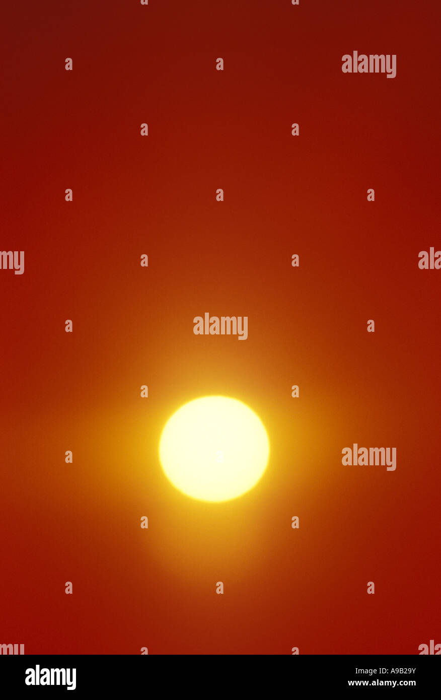 LARGE SUN IN CLEAR ORANGE SKY Stock Photo