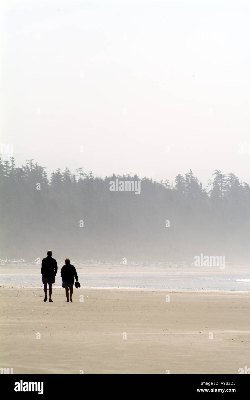Long Beach Mature couple walking on beach Pacific Rim National Park Reserve Vancouver Island British ColumbiaCanada Stock Photo