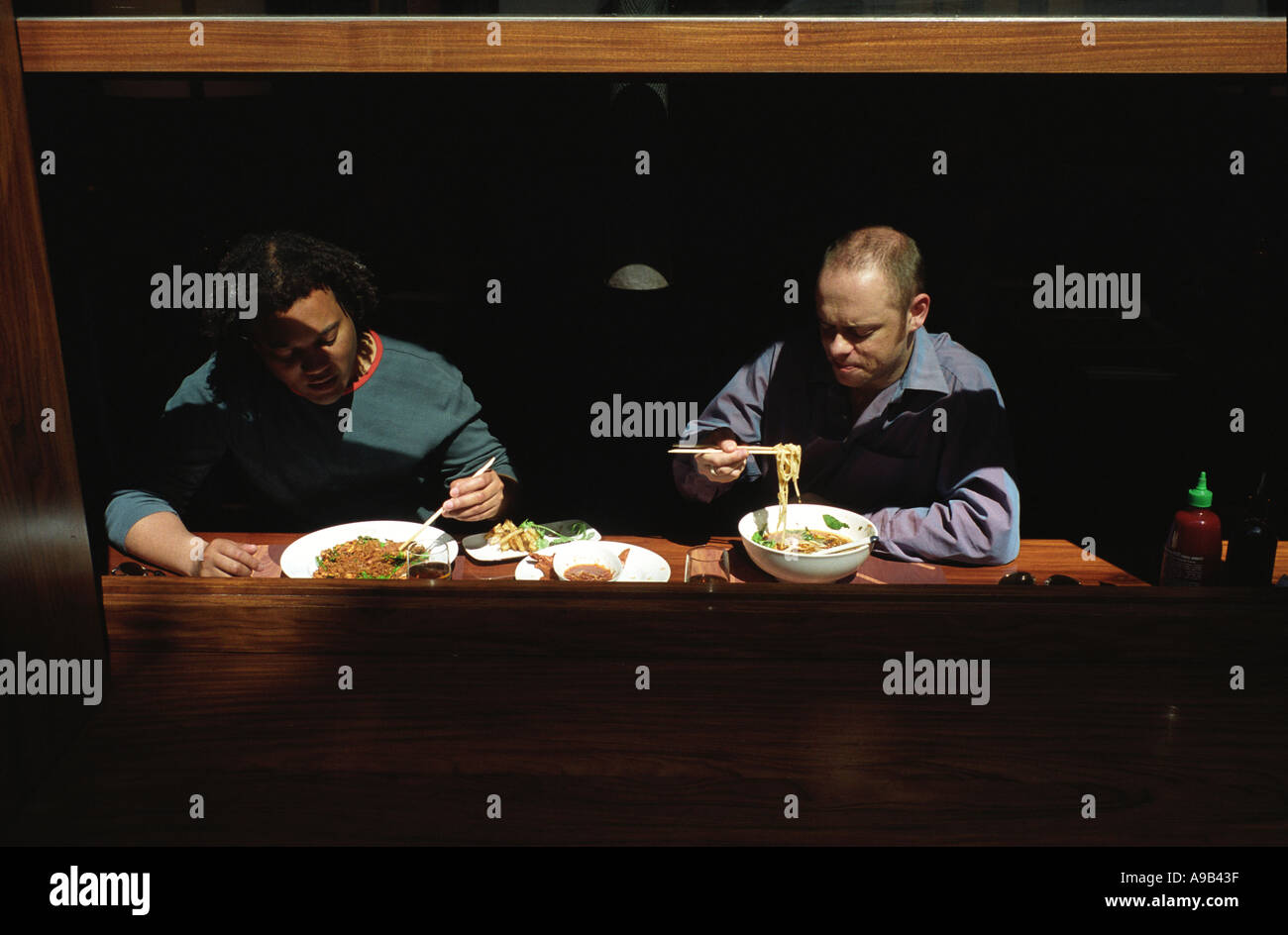 Two men eating noodles in a restaurant Soho London Stock Photo Alamy