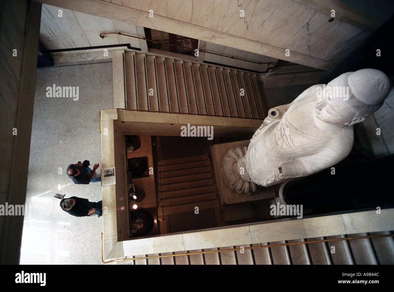 Visitors in front of a giant statue of Buddha British Museum London