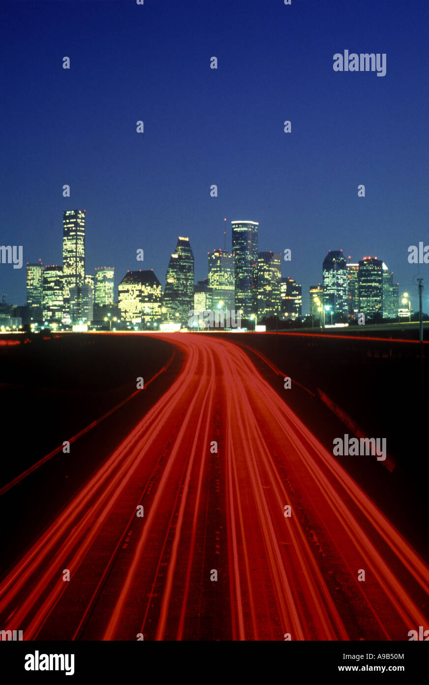 LIGHT TRAILS ON HIGHWAY DOWNTOWN SKYLINE HOUSTON TEXAS USA Stock Photo