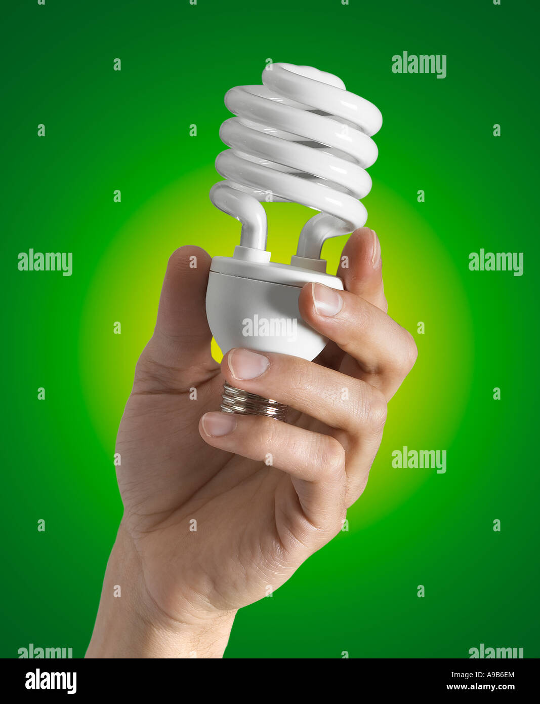 Energy Efficient Compact Fluorescent Light Bulb With Hand 'CFL Bulb' Stock Photo