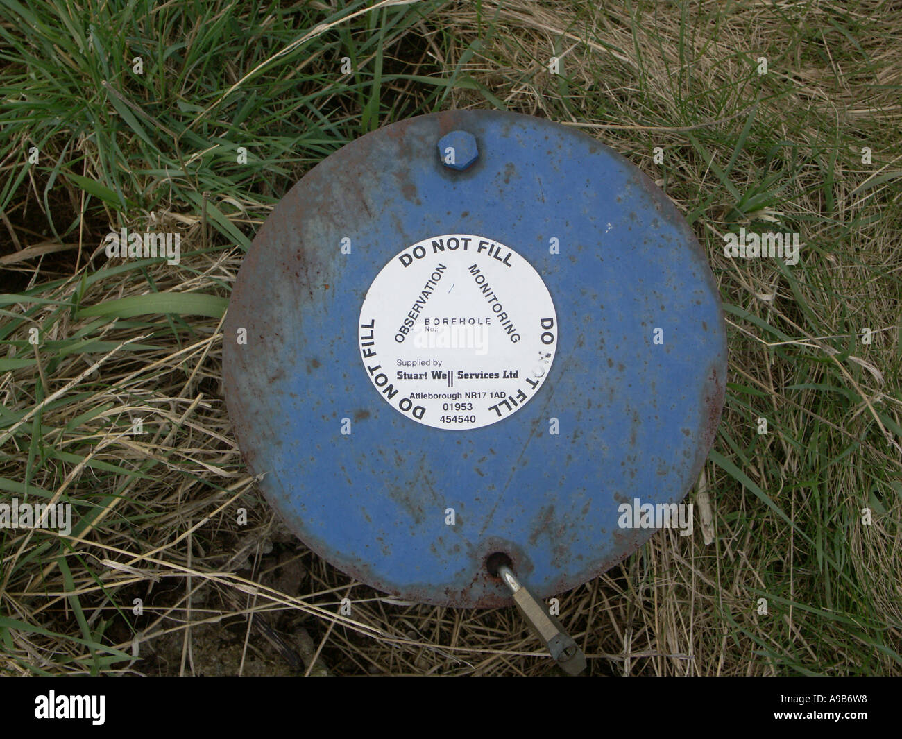 Bore hole or borehole inspection cover in a field Stock Photo Alamy