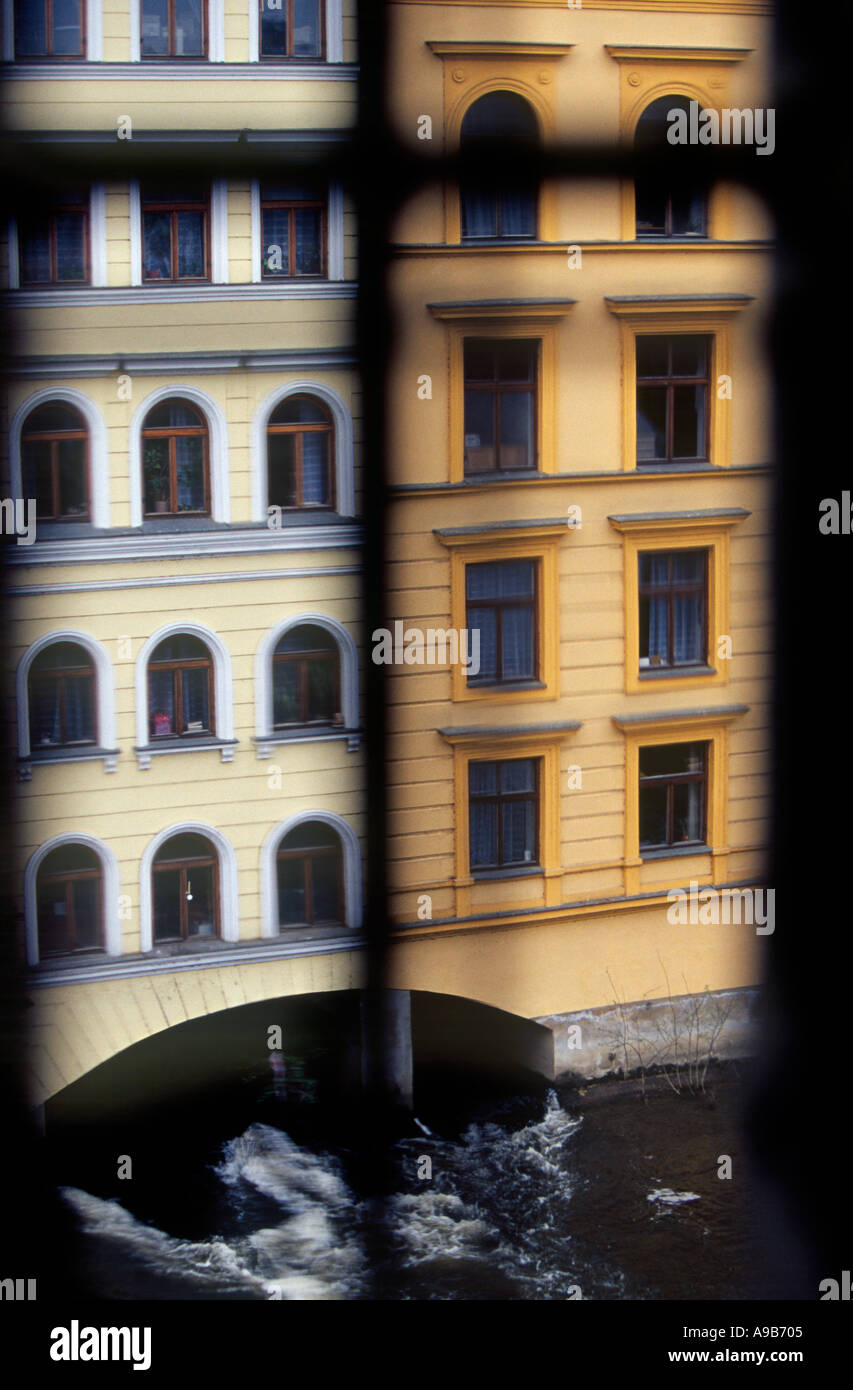 Two buildings on Vltava river water flows underneath seen from the Old Town Bridge Tower Prague Czech Republic Stock Photo
