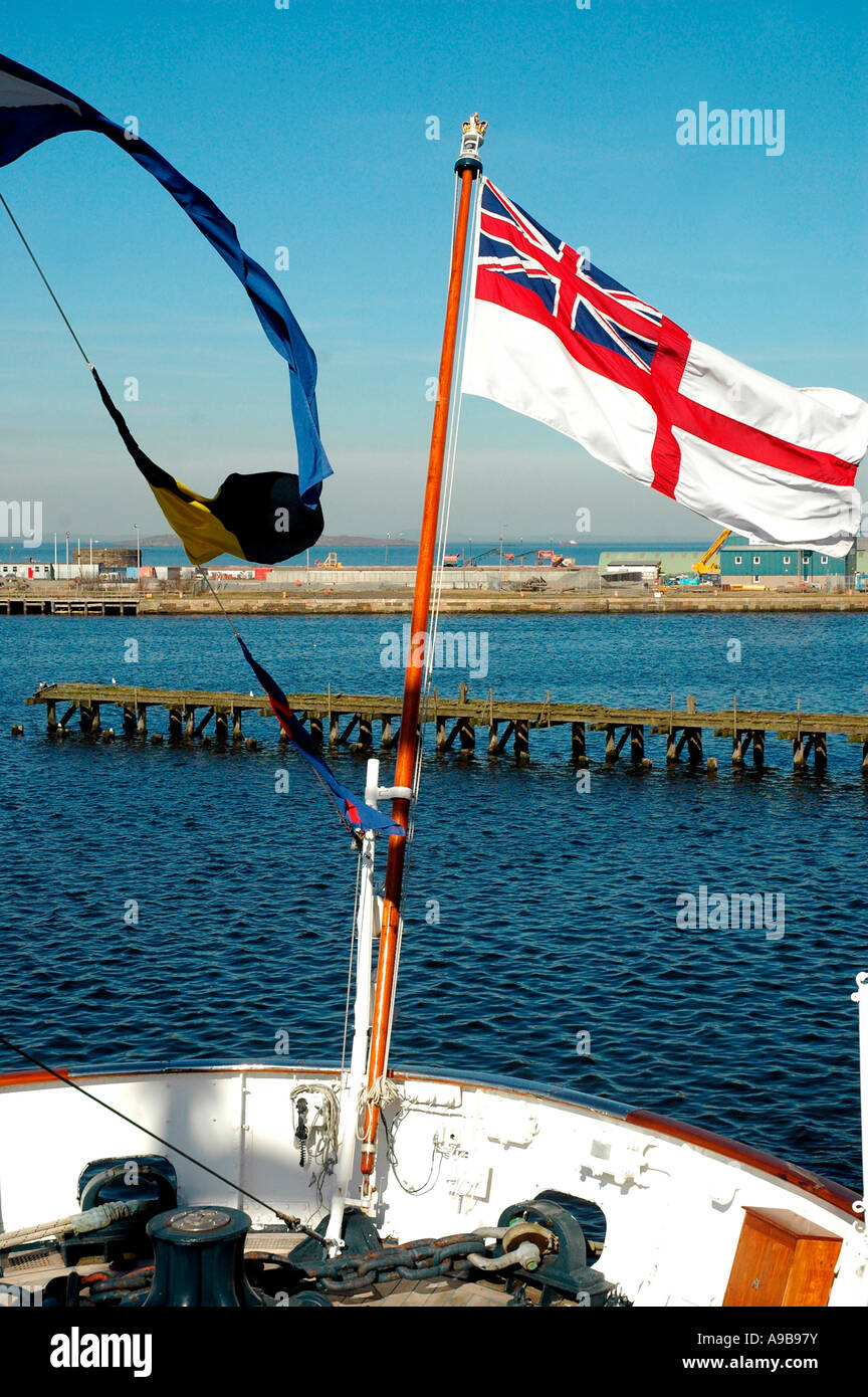 White Ensign flag flying from the Royal Yacht Britannia,Ocean Quay,Firth of Forth,Edinburgh,Scotland,United Kingdom Stock Photo