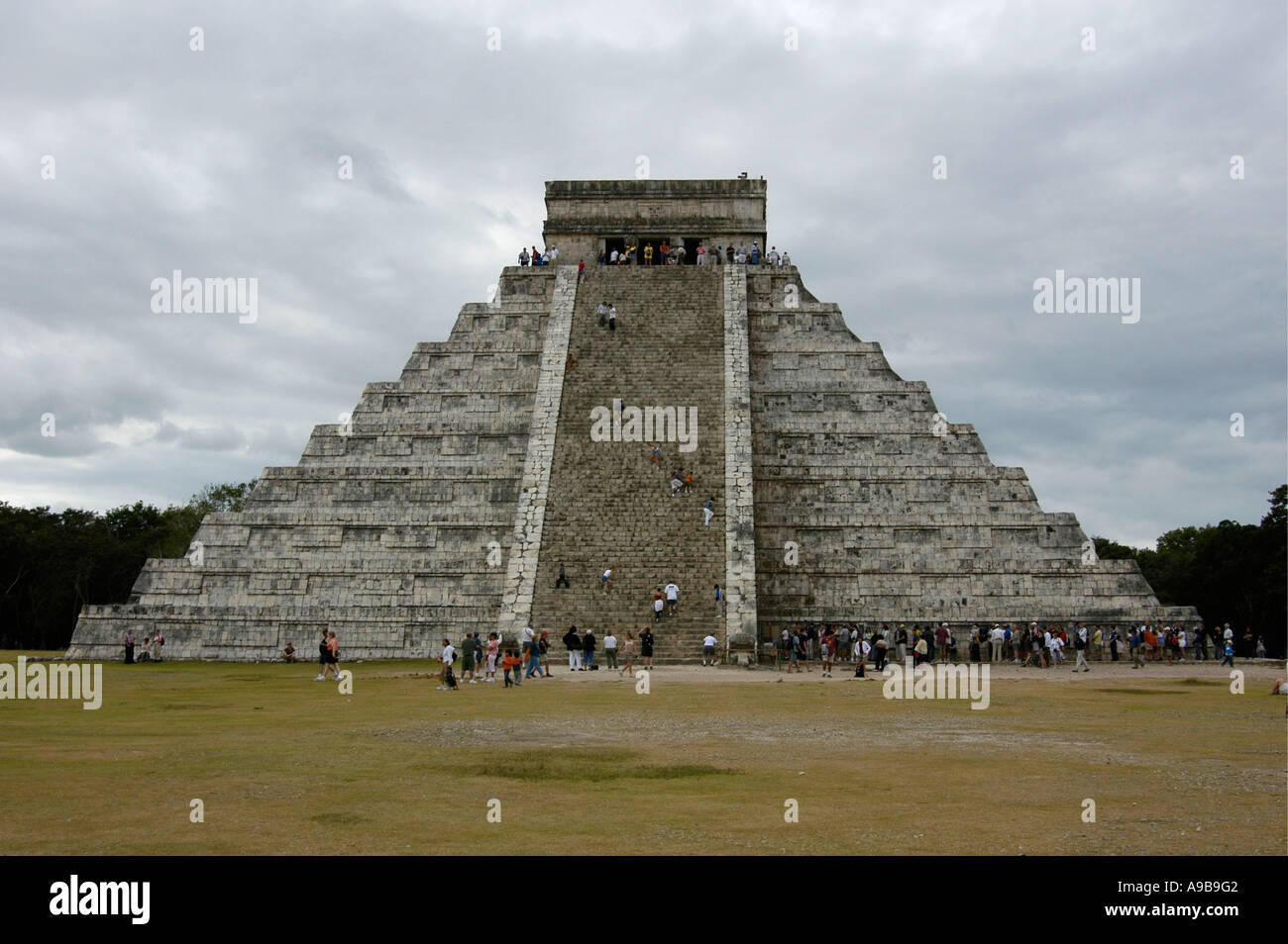 Visitors look at and climb Chichen Itza, the great Maya Toltec