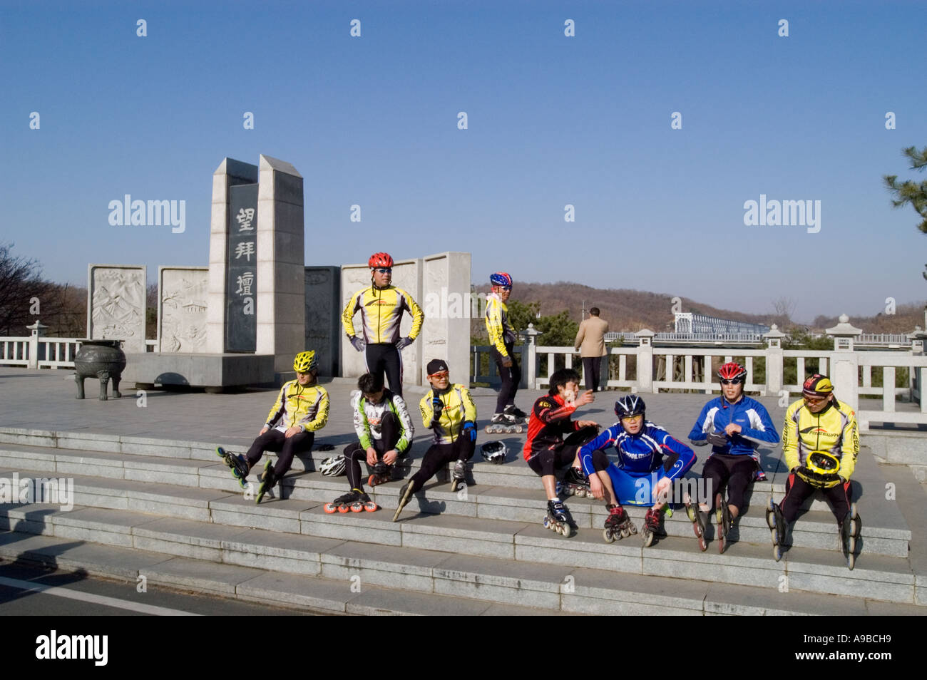 Rollerbladers visit the memorial altar near the Freedom Bridge at the DMZ in South Korea. Stock Photo