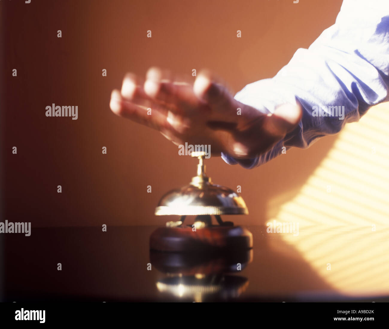 MANS HAND HITS HOTEL DESK SERVICE BELL Stock Photo Alamy