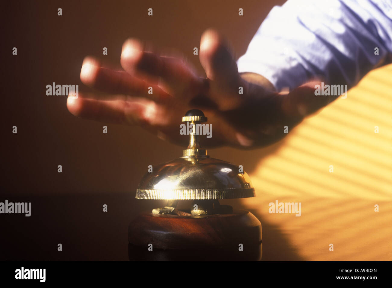 MANS HAND HITS HOTEL DESK SERVICE BELL Stock Photo Alamy