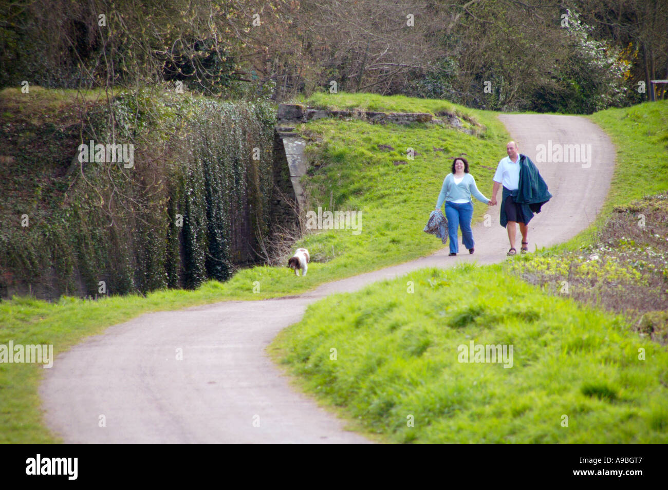 Couple walking hand in hand on the towpath of Monmouthshire and Brecon Canal Newport South Wales UK Stock Photo