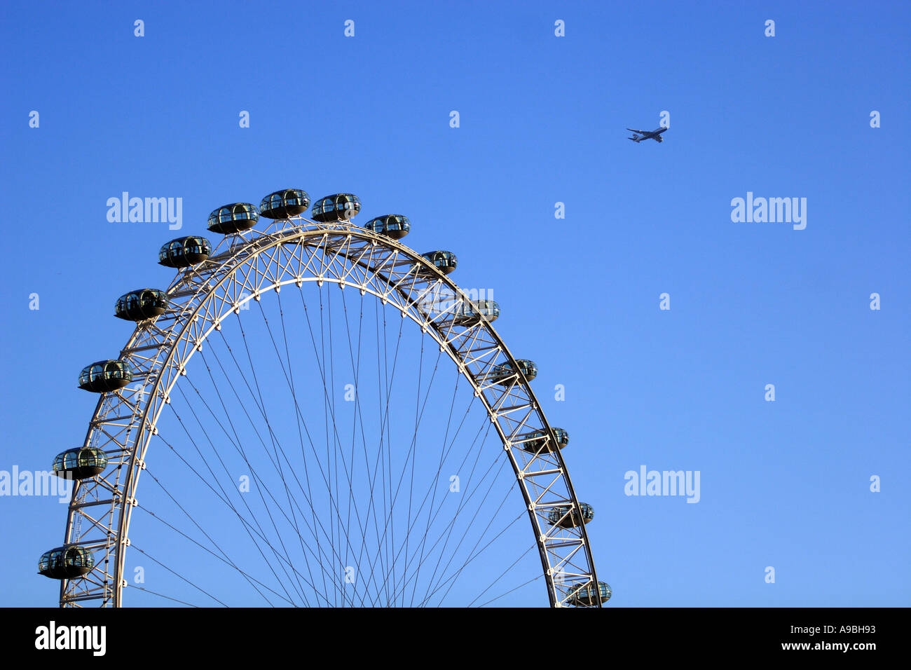 London Flying Activity The London Eye with an aeroplane flying past Stock Photo - Alamy