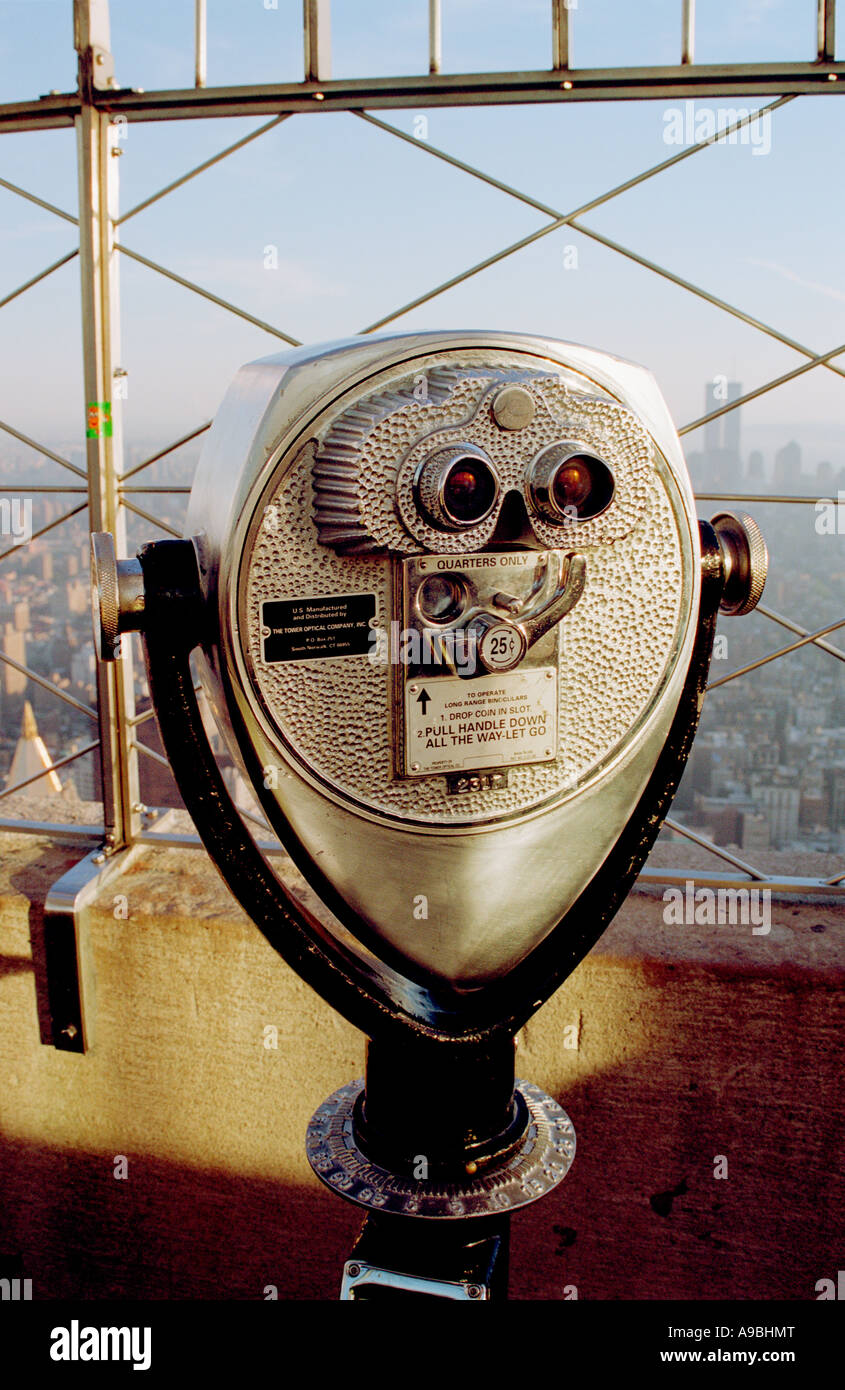 binoculars at the Empire State Building with a view of the New York skyline with the Twin towers of the World Trade Center Stock Photo