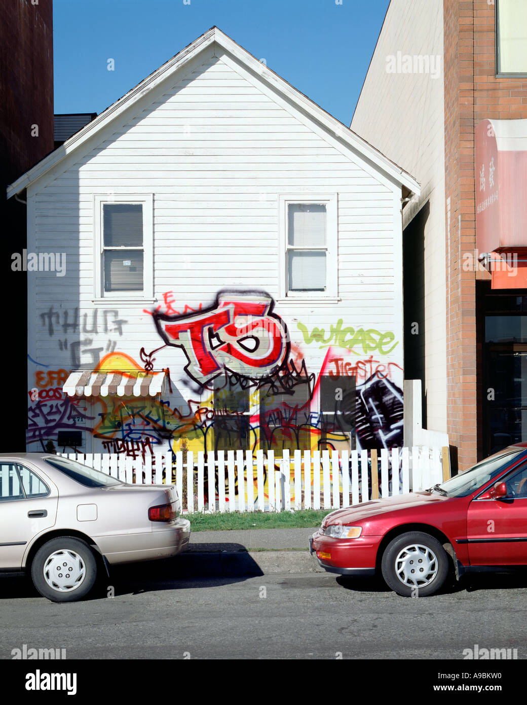 White clapboard house with graffiti Stock Photo