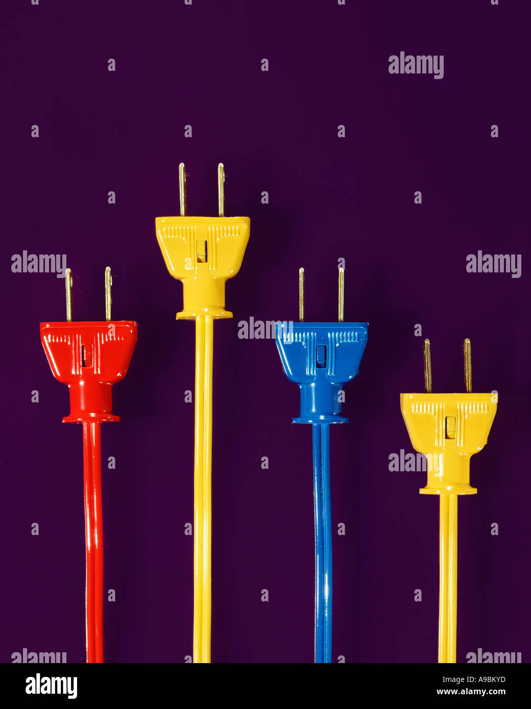 Coloured electrical plugs on purple background Stock Photo Alamy