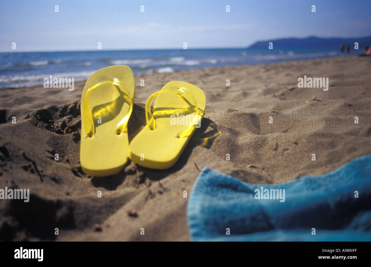Flip flops on sand at beach Stock Photo - Alamy