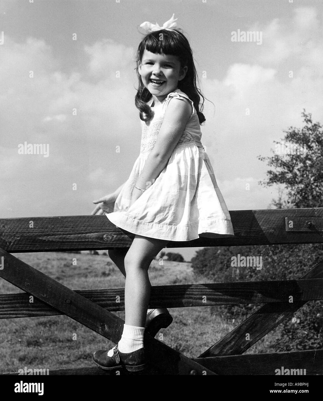 GIRL ON A GATE Stock Photo