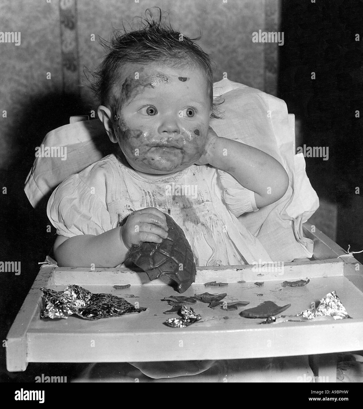 BABY WITH CHOCOLATE EGG Stock Photo