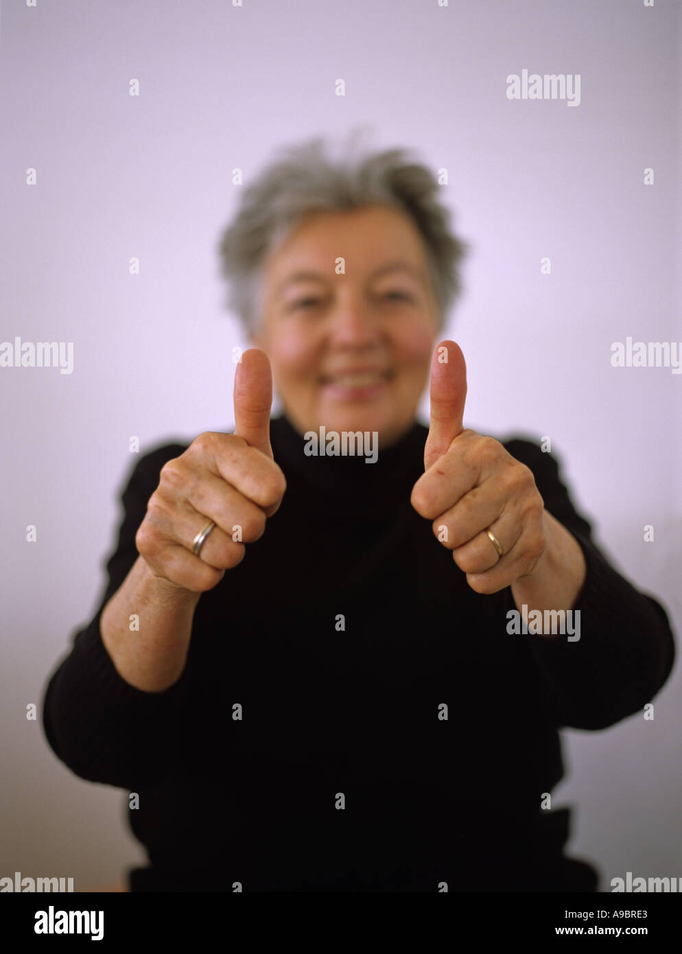 Senior woman showing thumb up sign, smiling, portrait Stock Photo - Alamy