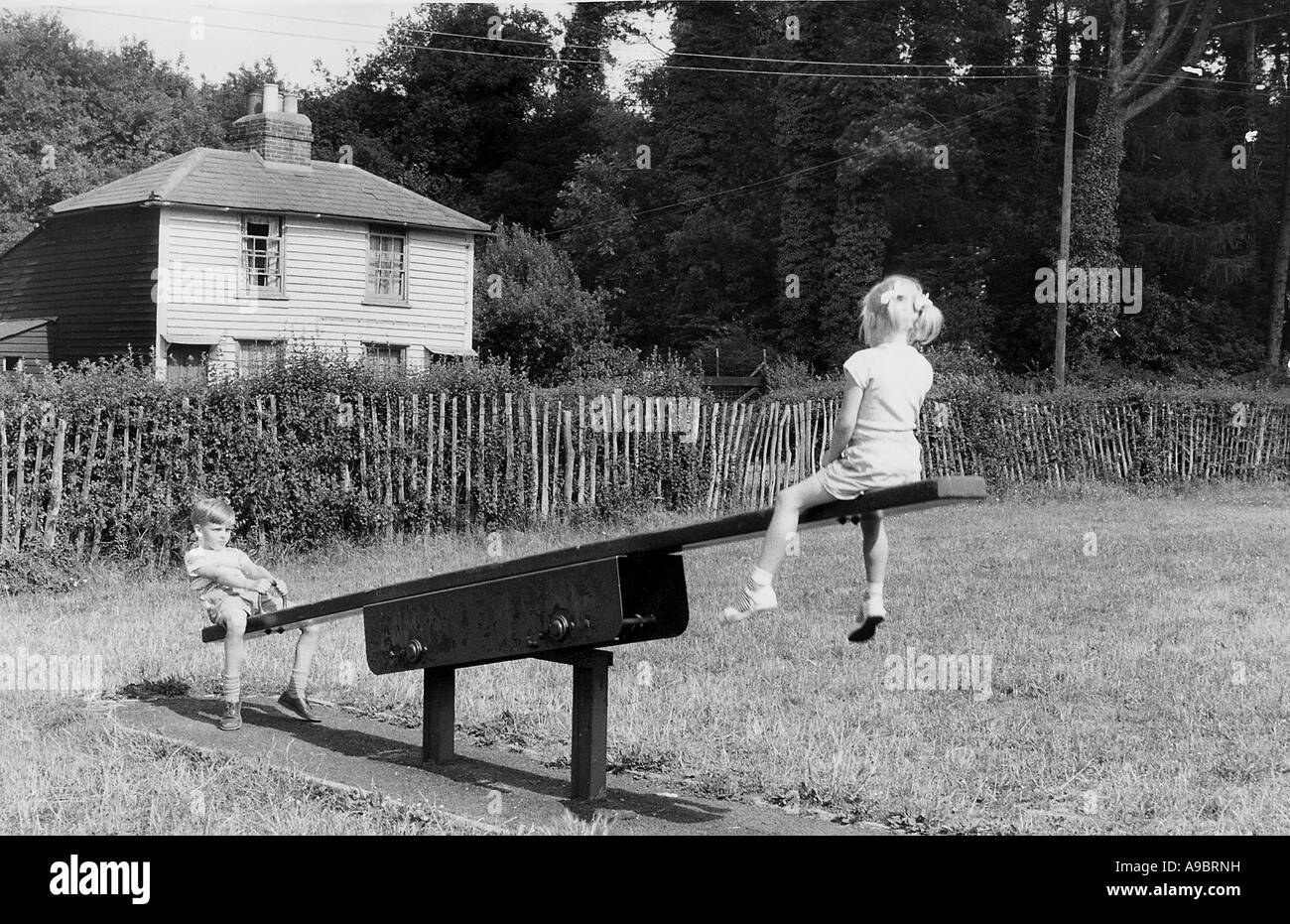 CHILDREN ON A SEESAW about 1950 Stock Photo
