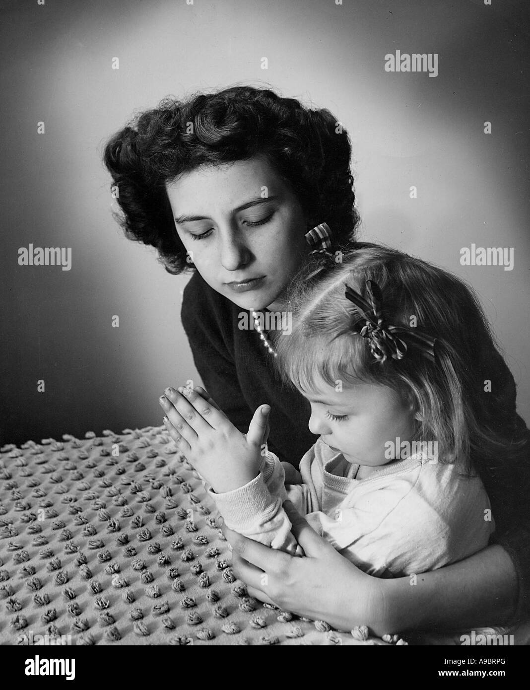 MOTHER AND CHILD AT PRAYER about 1945 Stock Photo