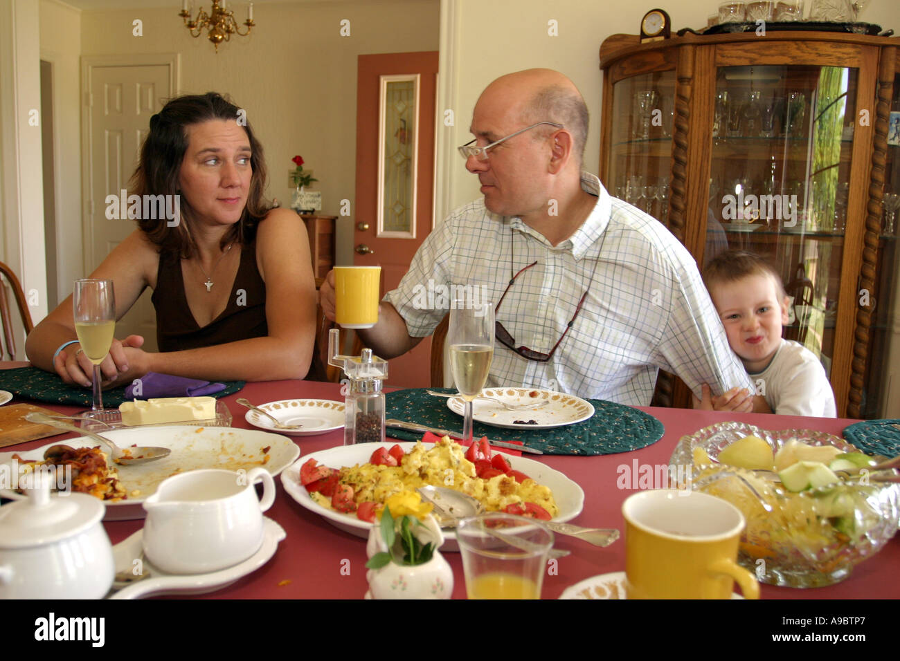 young child trying to get the attention of an adult Stock Photo