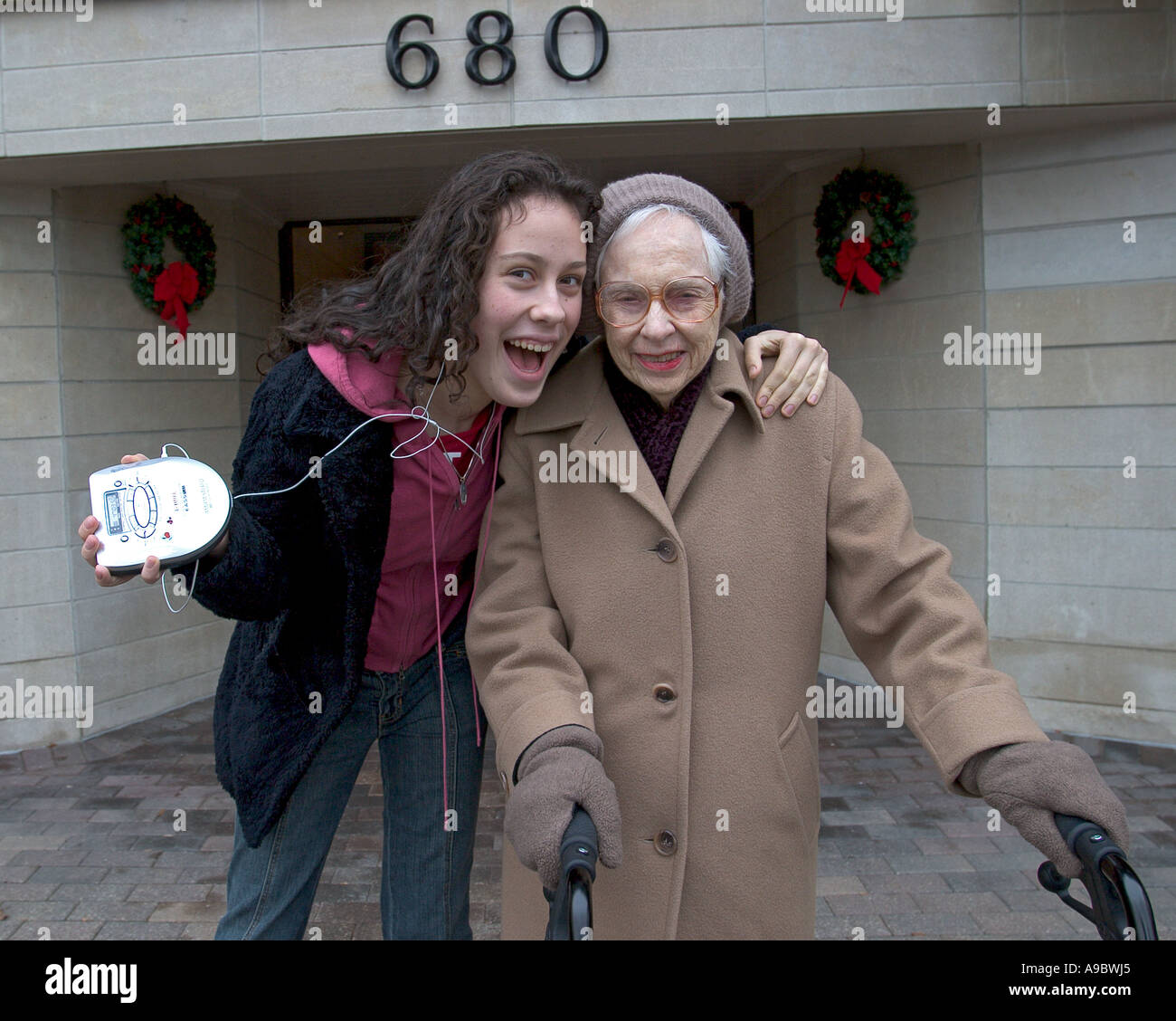 Happy teen with her 90 year old grandmother Stock Photo