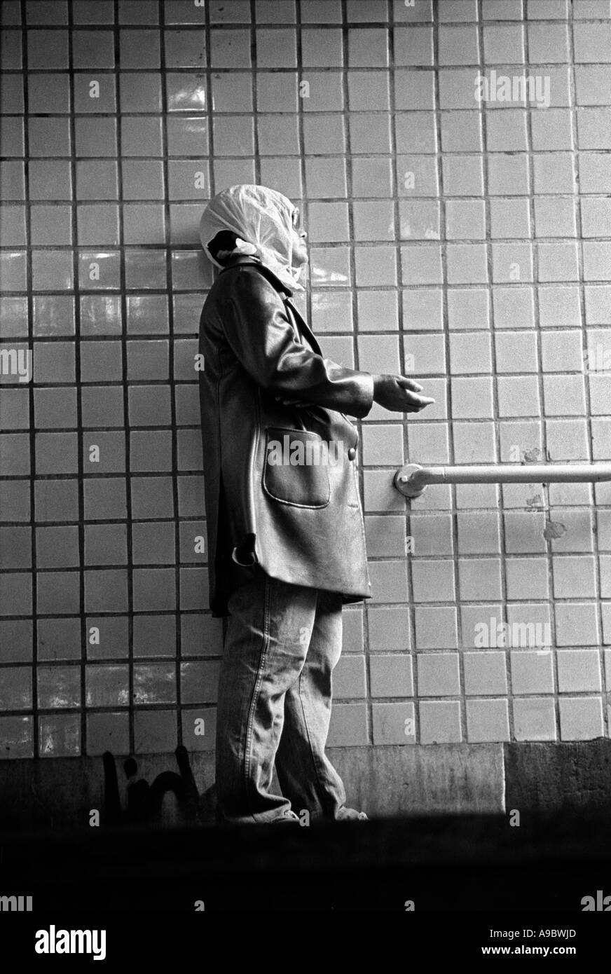 Woman begs for money at a subway entrance in New York City, 1980. Stock Photo