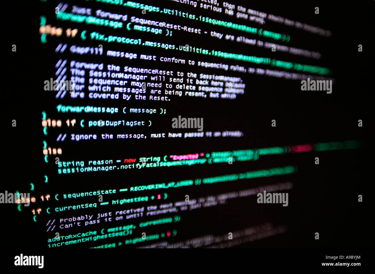 Highly technical looking computer program on screen in darkened room Stock Photo