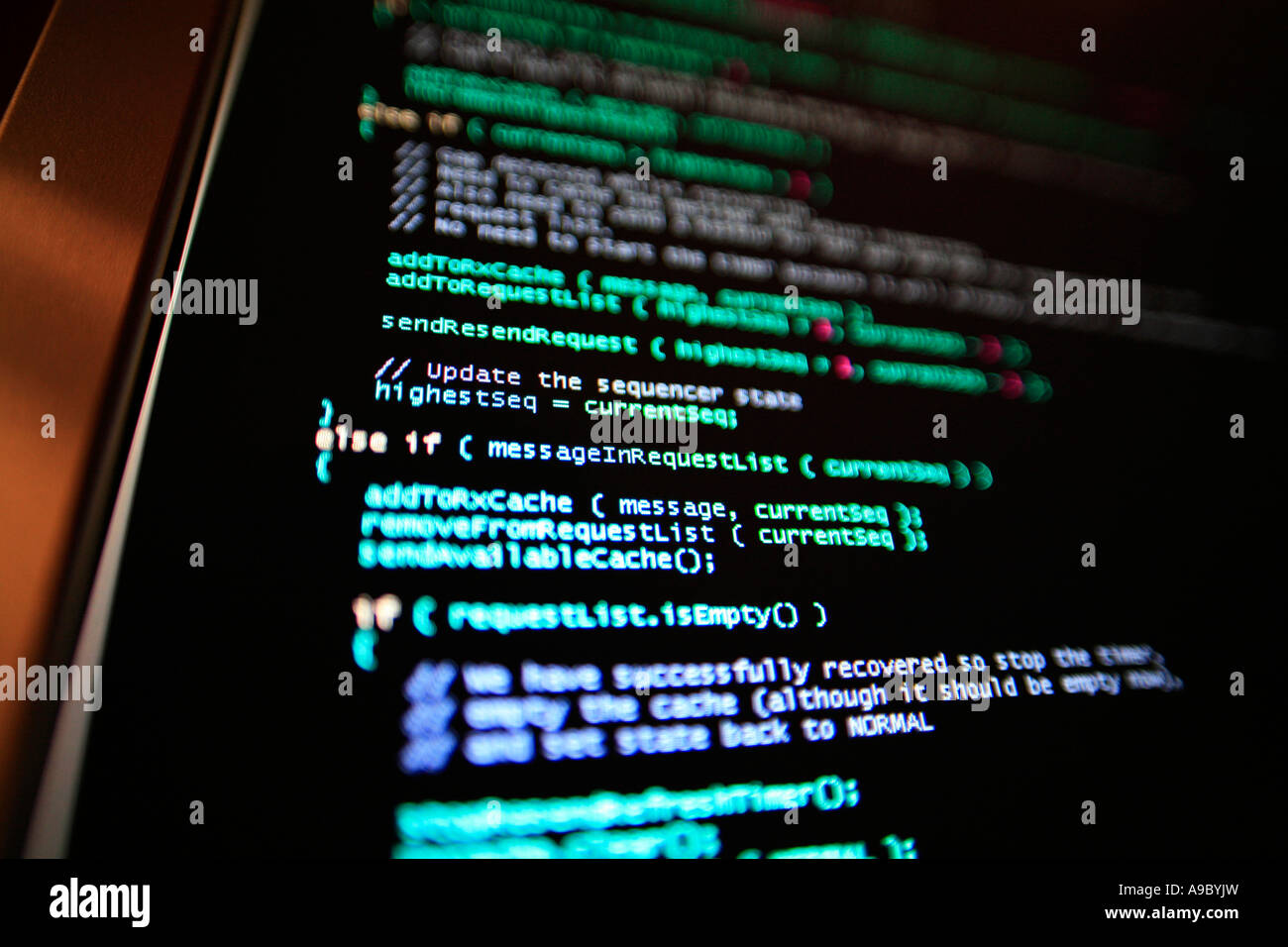Highly technical looking computer program on screen in darkened room Stock Photo