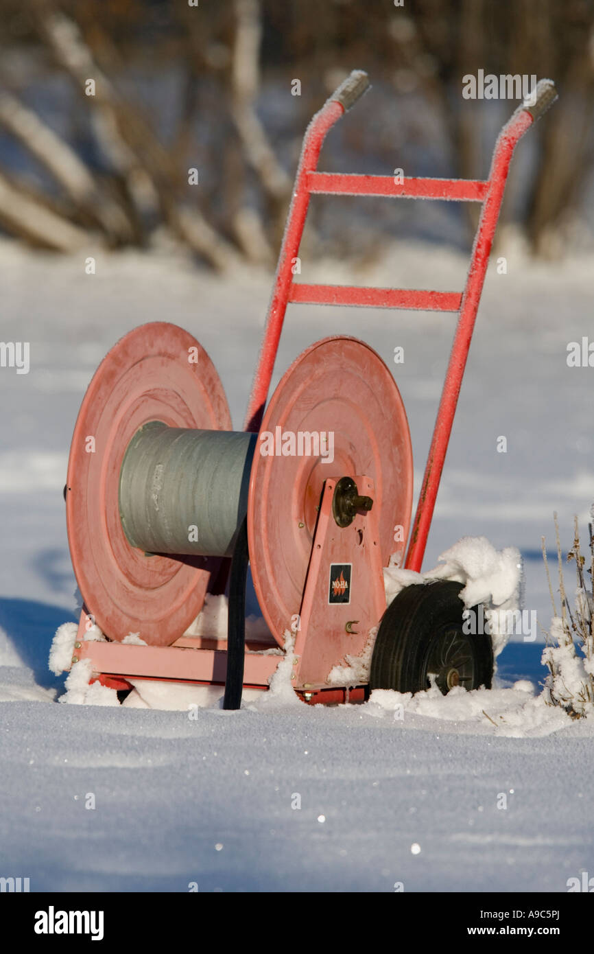 Empty red hose reel on snow , Finland Stock Photo - Alamy