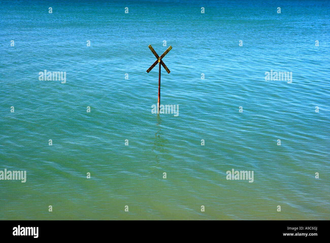 Coastal Outfall Hazard Sign at High Tide Stock Photo