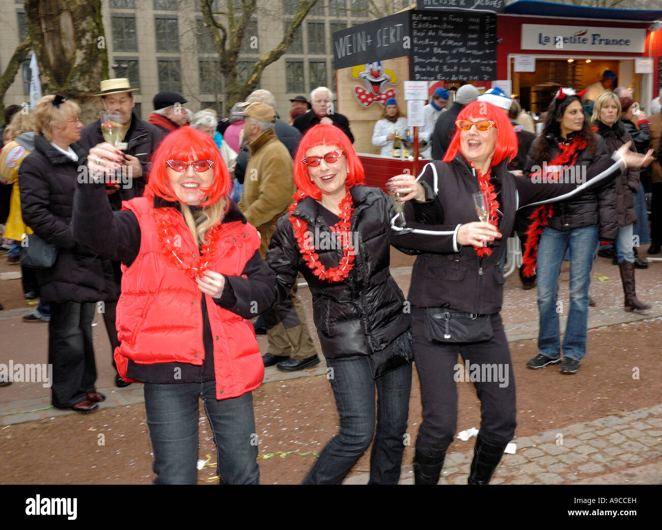 Dusseldorf carnival 2007. Three women with red wigs having a laugh. Stock Photo