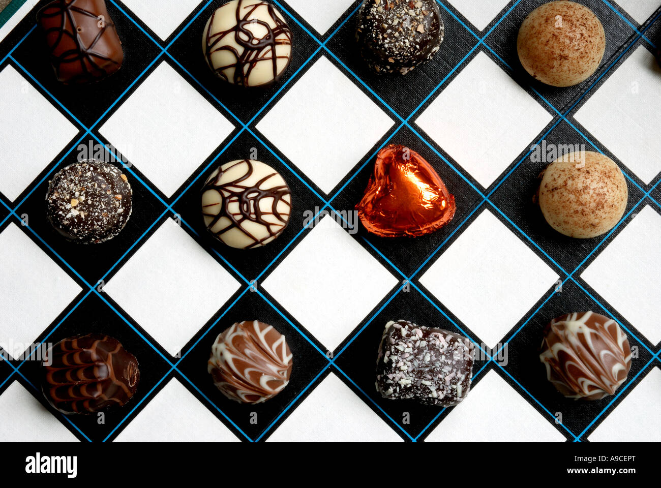 Fancy chocolates on a chess board Stock Photo