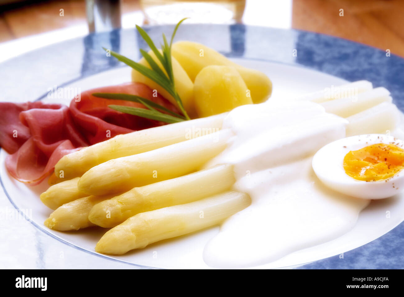 Asparagus with sauce hollandaise and roh bacon Stock Photo