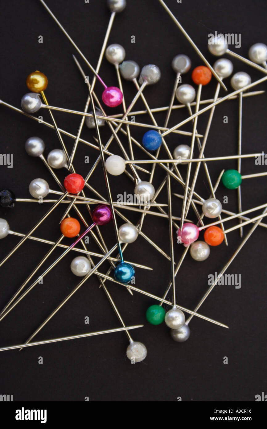 A PILE OF COLOURED PINS ON A BLACK BACKGROUND BAPD1482 Stock Photo - Alamy