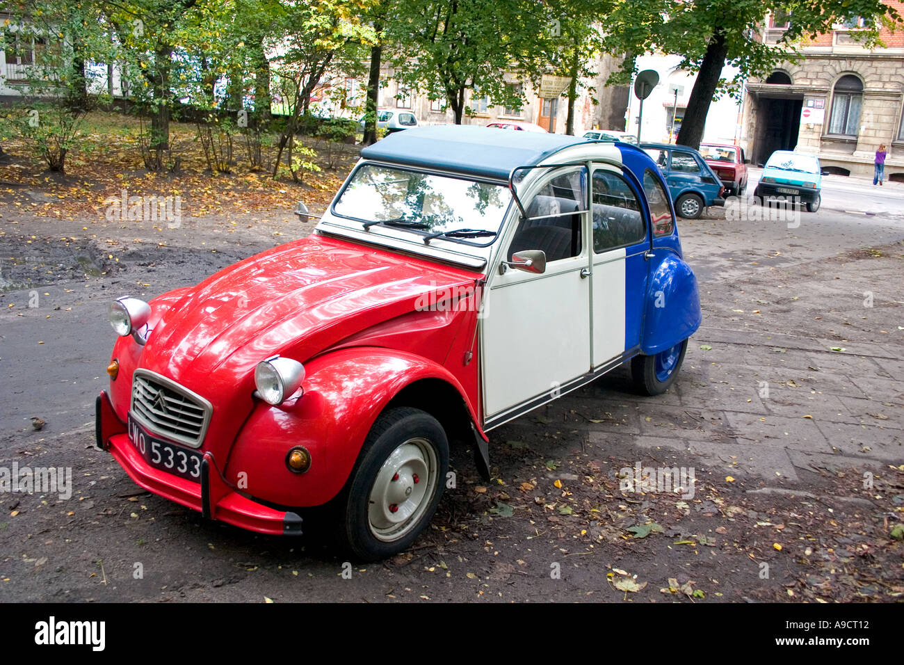 Beautiful red white and blue Citroen 2CV or French Deux Chevaux auto parked in courtyard. Lodz Poland Stock Photo