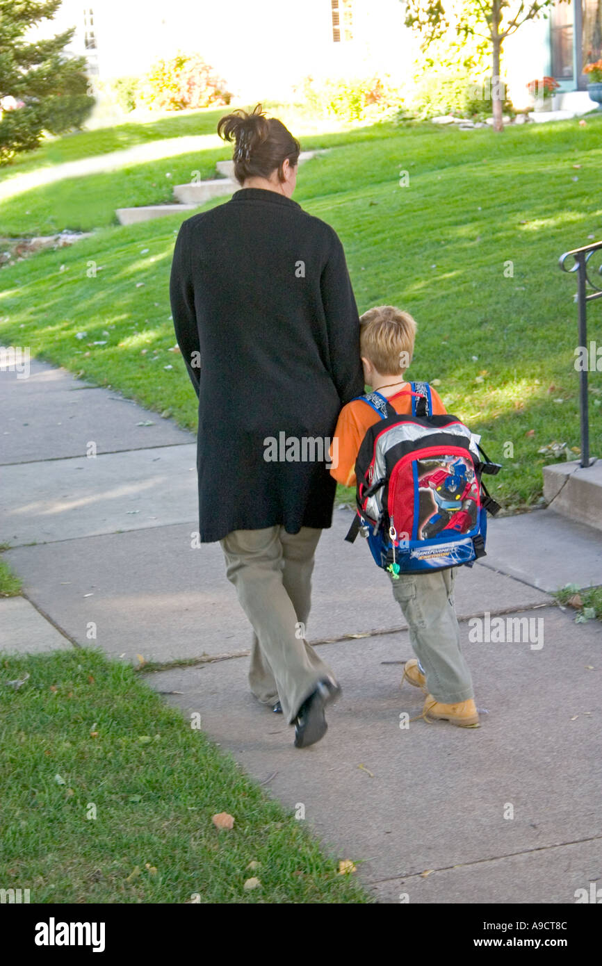 Son needing a little comfort from mom after returning from school. St Paul Minnesota MN USA Stock Photo
