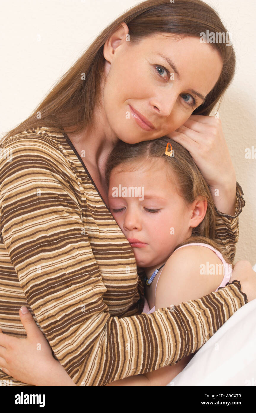 Portrait Of Mother Comforting Her Little Daughter Stock Photo