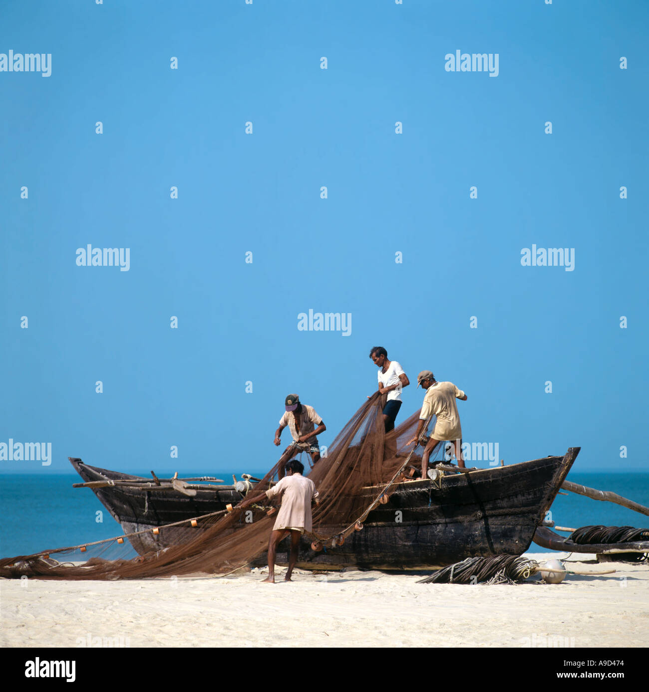 Fishermen pulling boat on beach hi-res stock photography and images - Alamy