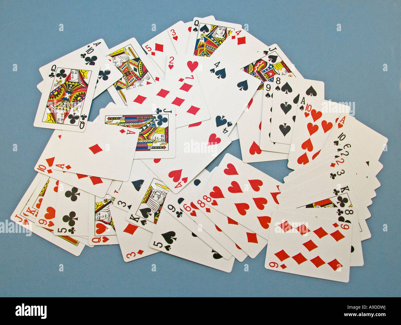 playing cards lying randomly on a table to illustrate chaos or randomness (see also A9DDWG) Stock Photo