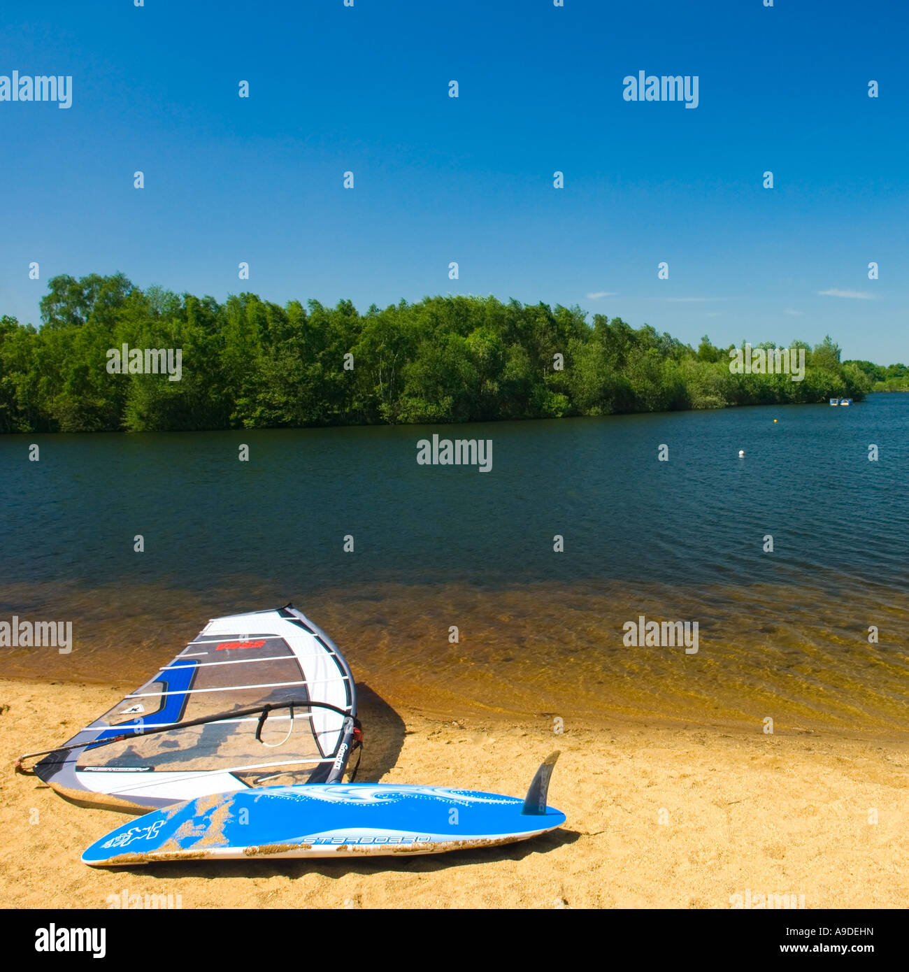 Windsurfing board lying on the beach of Horseshoe Lake in Trilakes