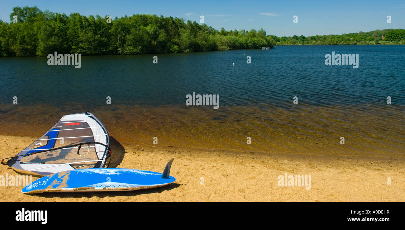 Windsurfing board lying on the beach of Horseshoe Lake in Trilakes
